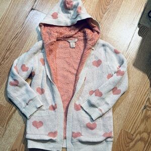 ' Cozy hooded jacket with heart pattern. Soft fabric.